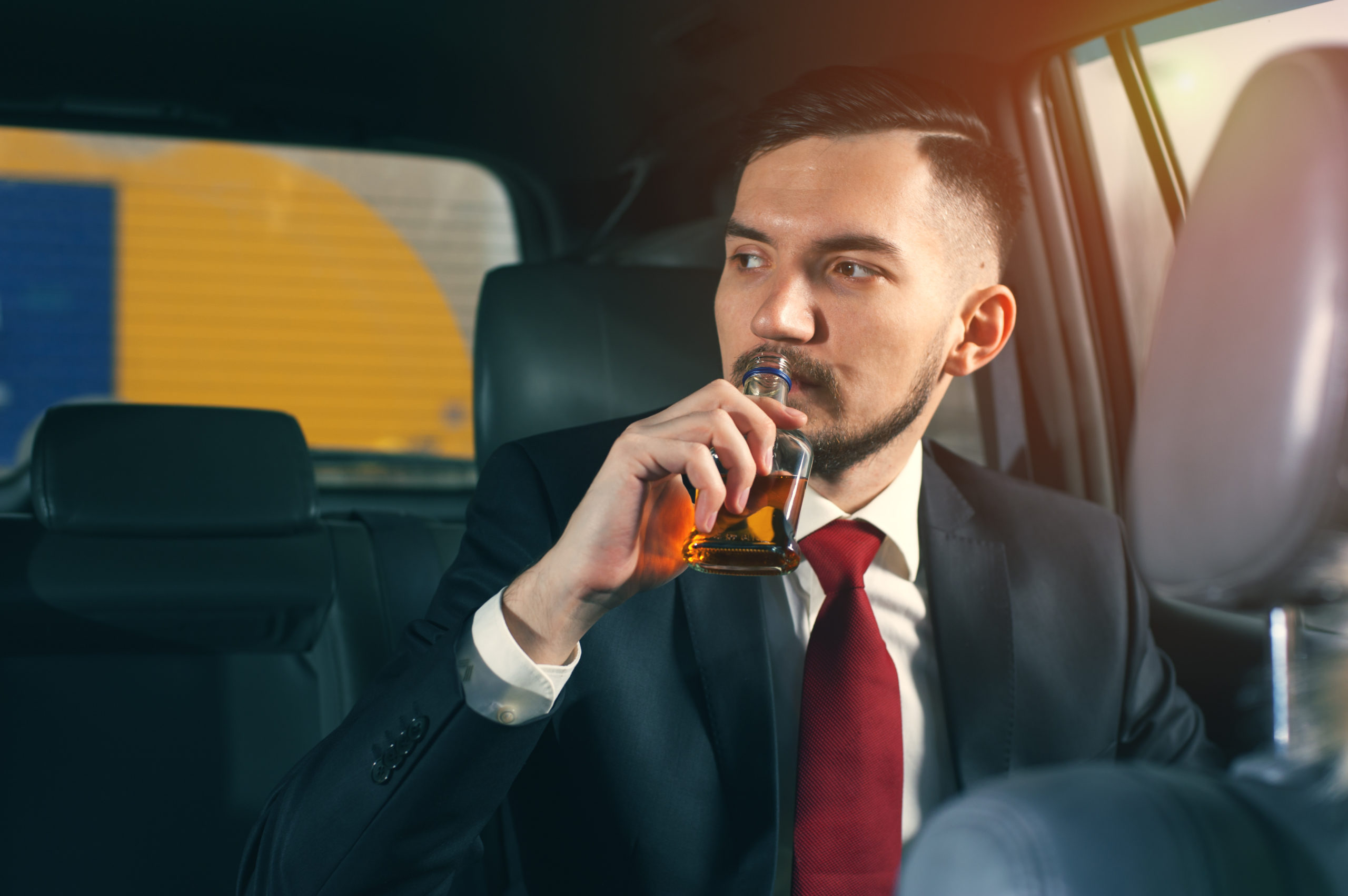 Young depressed businessman sitting in the car.