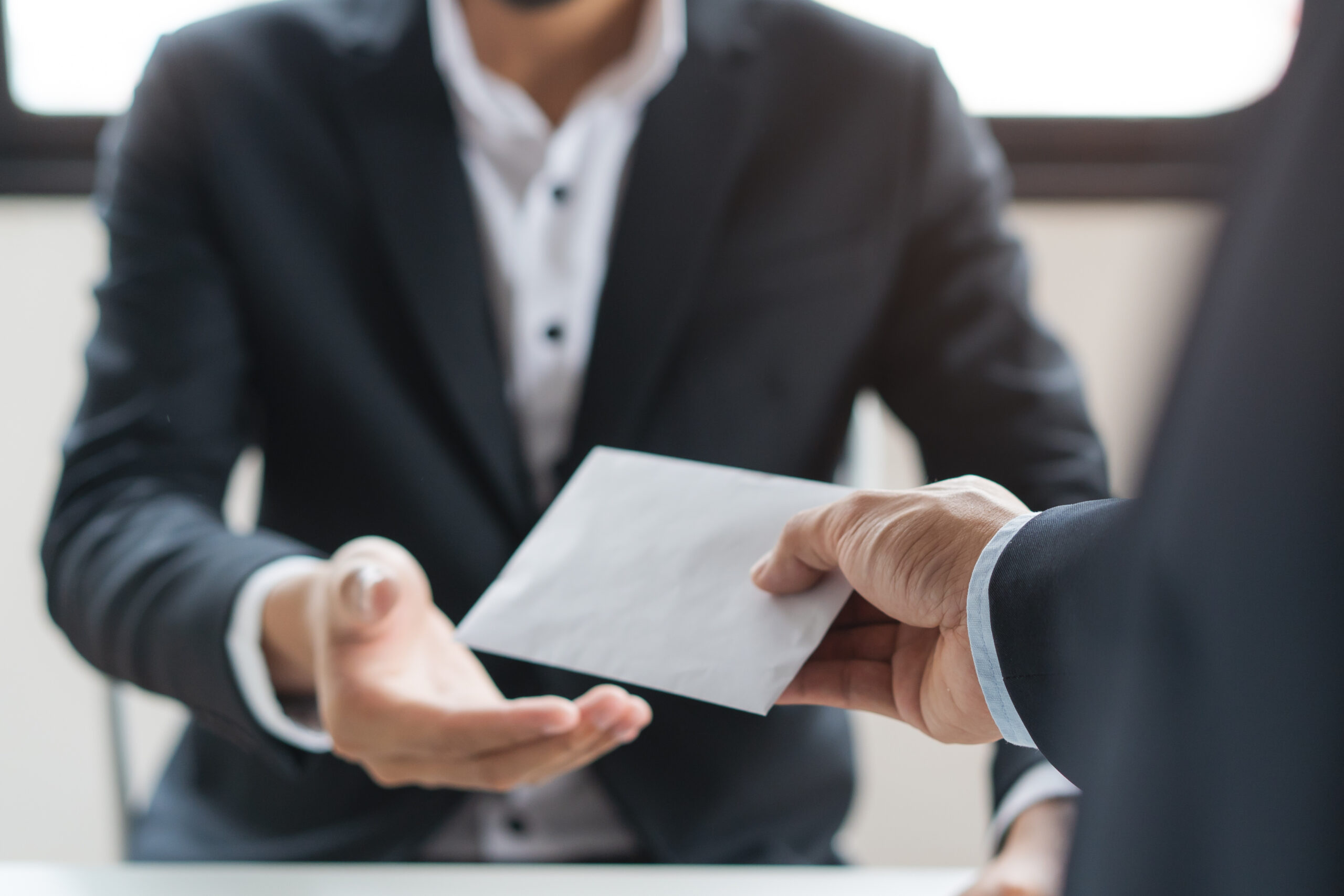 Close up view of office worker receiving salary from boss.