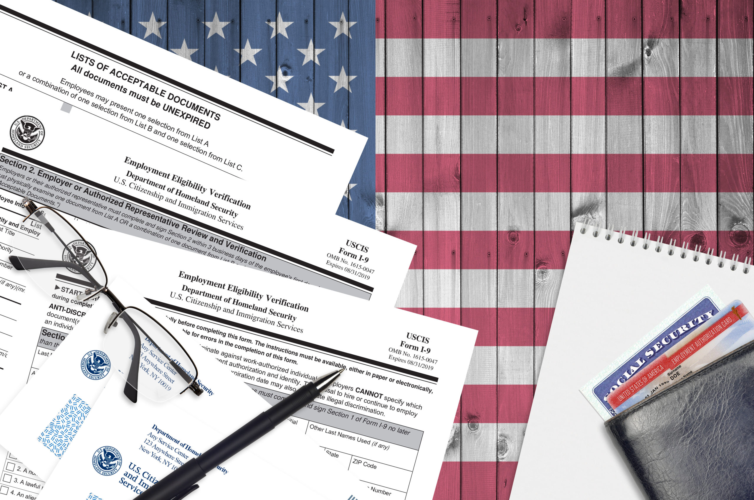 USCIS form I 9 Employment eligibility verification lies on flat lay office table and ready to fill. U.S. Citizenship and Immigration services paperwork concept