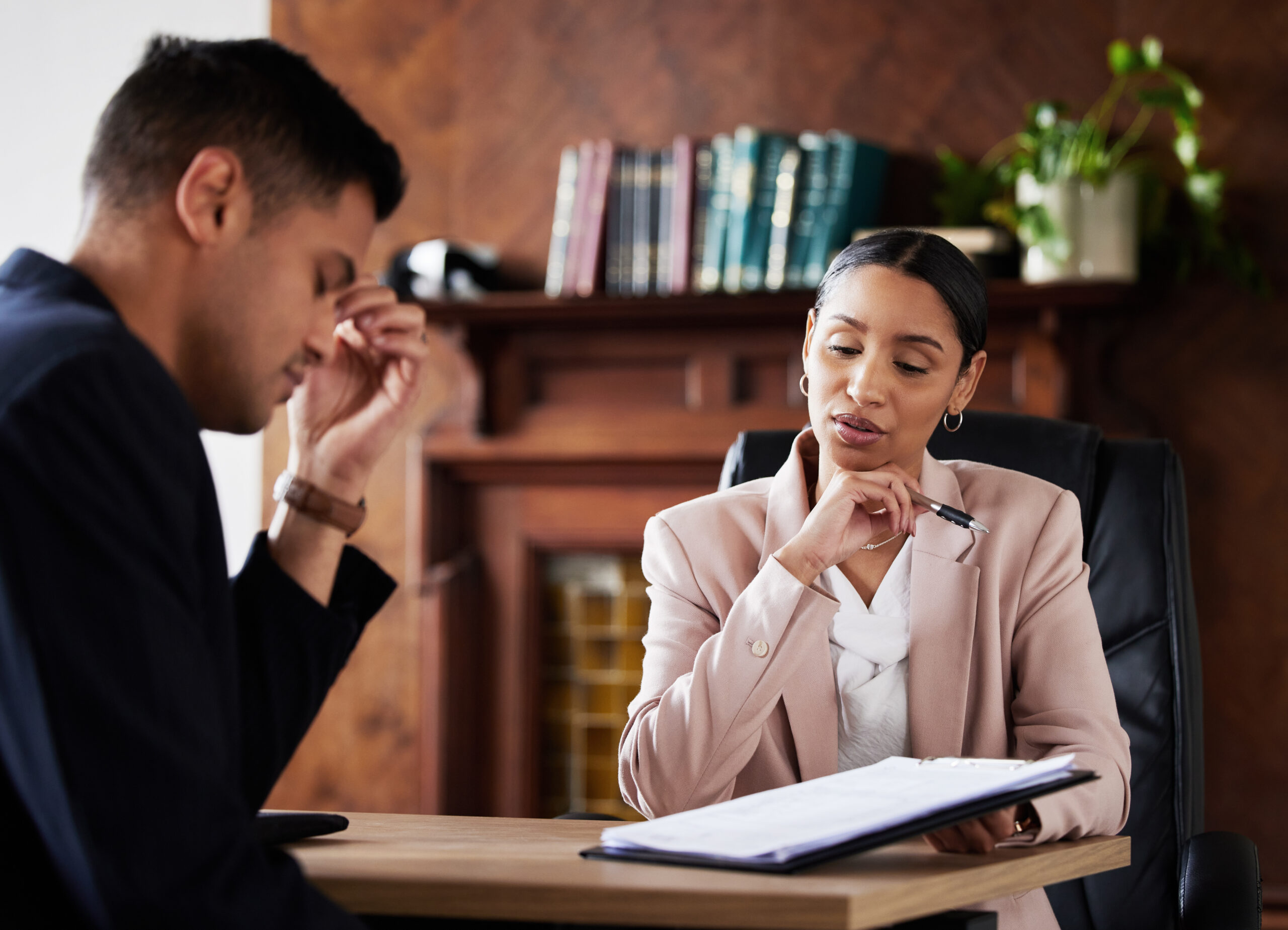 Corporate contract, woman lawyer and stress of client from legal documents and information. Business executer, will testament reading and sad man in a law firm office feeling upset about assets