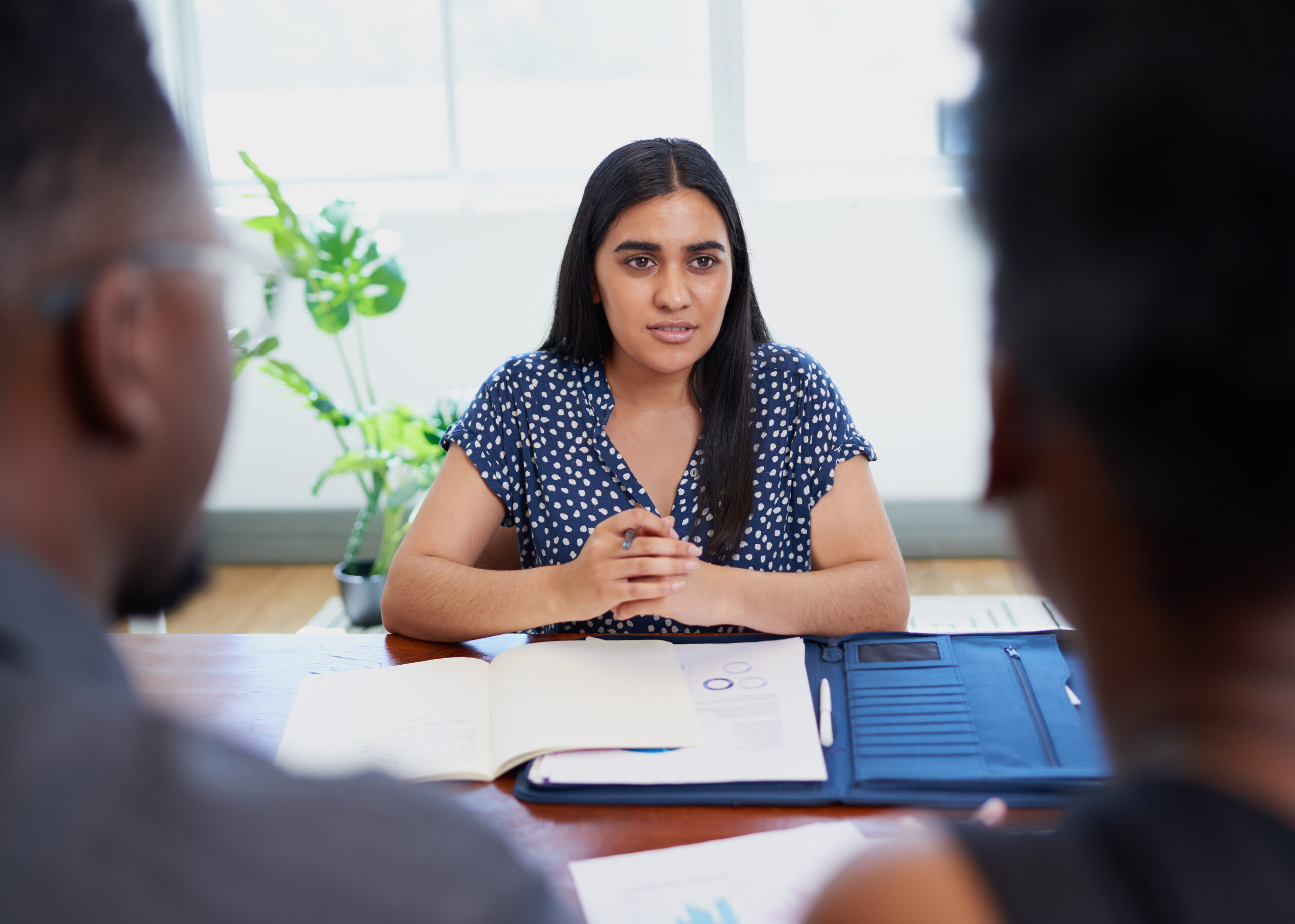 Young Indian mediator or lawyer meets with Black couple, financial advice